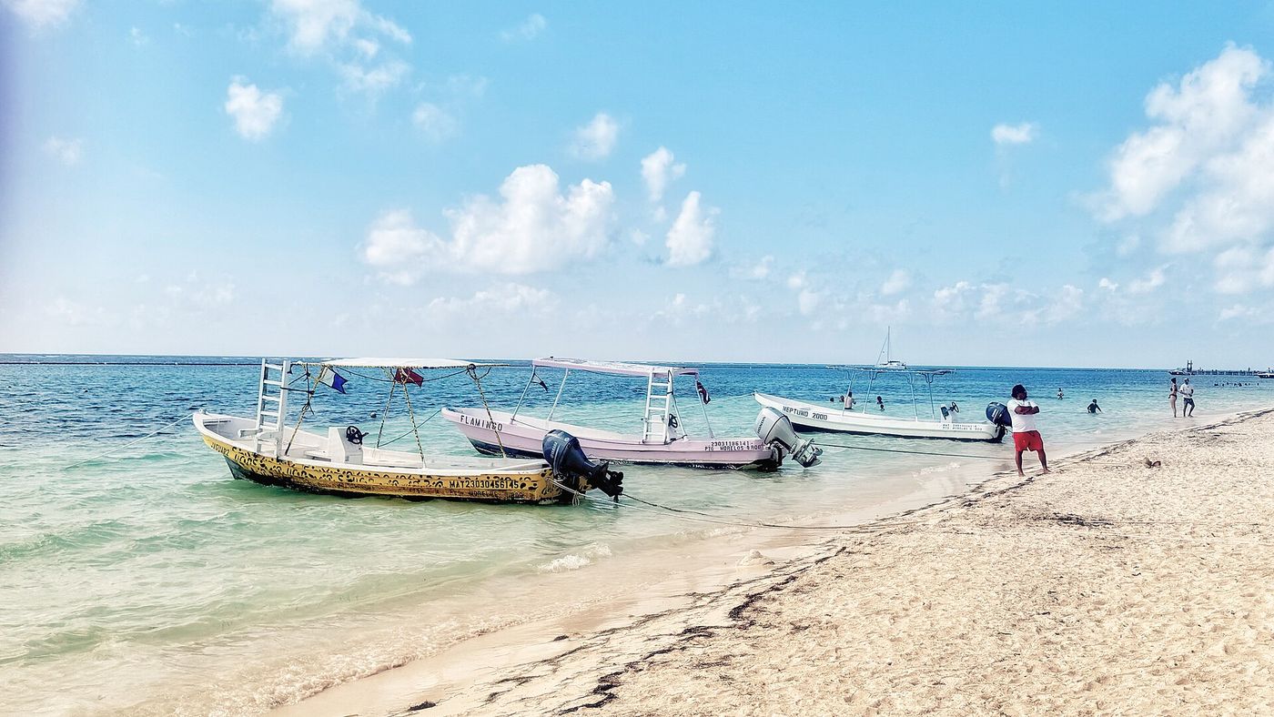 Colorful boats on the white sand beach of Puerto Morelos, Riviera Maya, Mexico